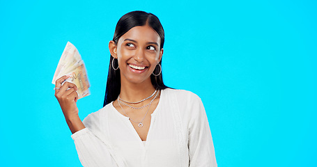 Image showing Rich, happy and face of a woman with money isolated on a blue background in a studio. Smile, wealth and a portrait of a girl fanning with cash, lottery jackpot and dollars from a bonus on a backdrop