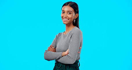 Image showing Face, smile and business woman with arms crossed in studio isolated on a blue background. Boss, professional and happy, funny and confident female entrepreneur from India with pride for career or job