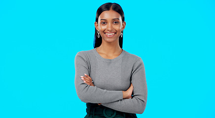 Image showing Smile, confident and portrait of businesswoman arms crossed excited, proud and isolated in a studio blue background. Leader, professional and female with a positive mindset relax, calm and happy