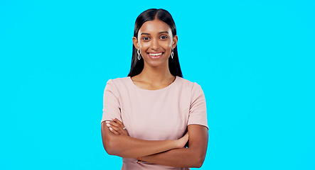 Image showing Smile, confident and portrait of woman arms crossed excited, proud and isolated in a studio blue background. Leader, confidence and female with a positive mindset relax, calm and happy person