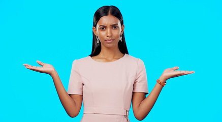 Image showing Choice, option or decision and a woman on a blue background in studio with a hand gesture. Portrait, balance and scale with an attractive young female weighing up the pros and cons of a variable