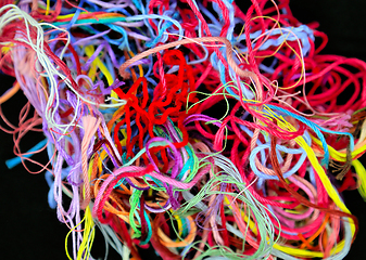 Image showing Close-up of multicolored tangled threads for needlework on black