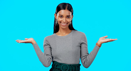 Image showing Choice, option or decision and a woman on a blue background in studio with a hand gesture. Portrait, balance and scale with an attractive young female weighing up the pros and cons of a variable