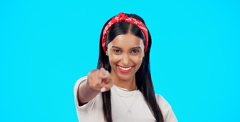 Image showing Face, motivation and woman pointing to you, winner and promotion against blue studio background. Portrait female and lady with smile, show with finger or success with choice, opportunity or selection