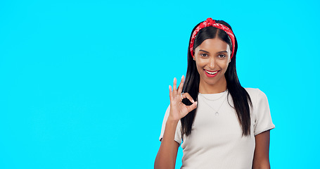 Image showing Okay gesture, studio and happy woman point at sales promo, present gift or discount deal mockup. Female portrait, good advertising space and marketing product placement for person on blue background