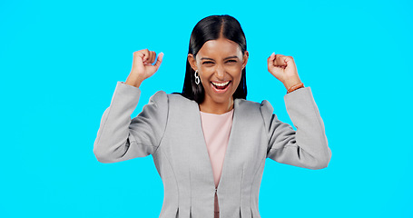 Image showing Yes, winning and woman cheers isolated on blue background celebration, excited and fist pump for lotto. Wow, happy winner or indian person face to celebrate prize, competition or bonus news in studio