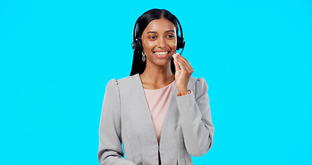 Image showing Call center, crm or Indian woman in studio for communication isolated on blue background. Customer services, mockup or friendly girl in headset helping, talking or explaining at technical support