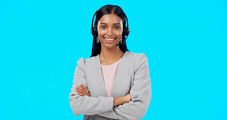 Image showing Call center, portrait or Indian woman in studio for communication isolated on blue background. Face smile, mockup or friendly girl in headset helping at technical support, telecom or customer service