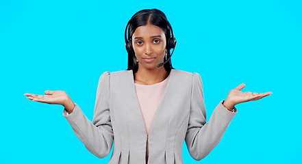 Image showing Call center, portrait or woman confused with choice, doubt or opinions in studio isolated on blue background. Decisions, mockup space or Indian girl with confusion at telecom crm customer services