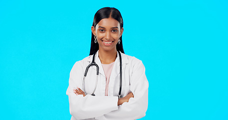 Image showing Studio woman, confidence and happy doctor, female surgeon or nurse for support, medical healthcare or health. Medicine professional pride, cardiology portrait and hospital person on blue background