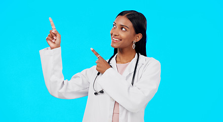 Image showing Healthcare doctor, studio and happy woman point at medical promotion, hospital notification or clinic announcement mockup. Nurse portrait, advertising surgeon and marketing person on blue background