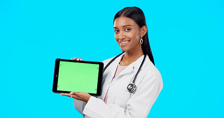 Image showing Tablet, green screen and doctor face isolated on blue background telehealth, medical or service software app. Healthcare professional or indian person on digital technology, studio and mockup space