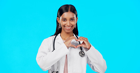 Image showing Heart gesture, happy woman and medical doctor, surgeon or nurse care for support, medicine healthcare or cardiology health. Emoji love sign, studio portrait or hospital female help on blue background