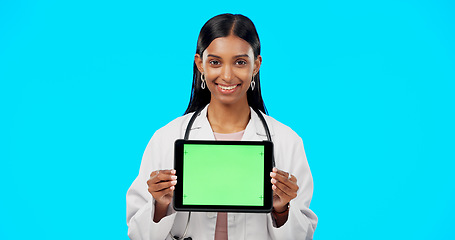 Image showing Tablet, green screen and doctor face isolated on blue background telehealth, medical or service software app. Healthcare professional or indian person on digital technology, studio and mockup space