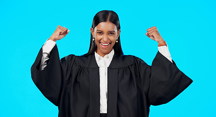 Image showing Woman, bicep muscle celebration and studio with excited face for legal victory for smile by blue background. Judge, lawyer or indina law expert in portrait to celebrate winning court case by backdrop