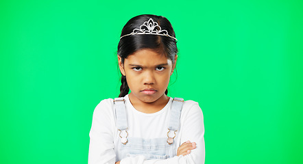 Image showing Angry, upset and child with crossed arms on green screen with crown, princess costume and tutu in studio. Portrait, behavior mockup and isolated young girl with anger, disappointed and mad expression