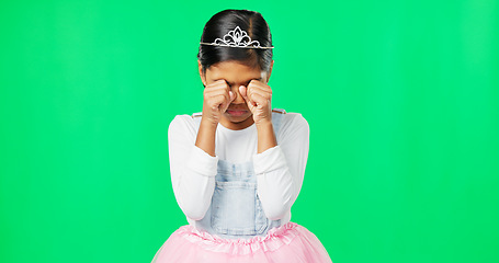 Image showing Sad, depression and child crying on green screen with crown, princess costume and tutu in studio. Sadness mockup, tears and isolated young girl with worried, upset and disappointed facial expression