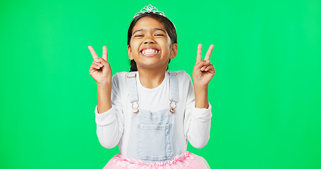 Image showing Peace, fun and hand gesture with a girl on a green screen background in studio feeling silly or carefree. Portrait, dance and emoji with an adorable little female child looking goofy or playful