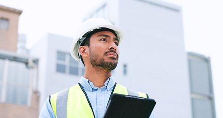 Image showing Construction worker holding a digital tablet while doing inspection. Organized male engineer or technician in a hardhat checking project plan with latest tech. Worker looking or overseeing operations