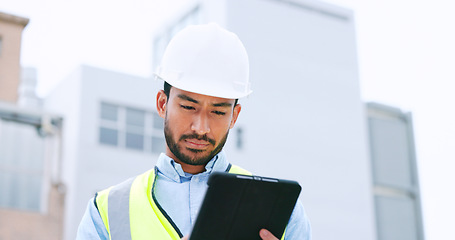 Image showing Construction worker holding a digital tablet while doing inspection. Organized male engineer or technician in a hardhat checking project plan with latest tech. Worker looking or overseeing operations