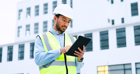 Image showing Male engineer checking data on digital tablet and inspecting construction site. Technician in a hardhat doing management and project planning outdoors. Skilled worker looking or overseeing operations