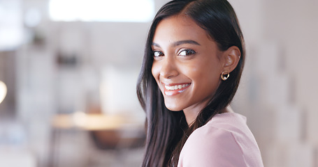 Image showing Trendy businesswoman looking happy and smiling while sitting in her office. Creative professional with a positive attitude and mindset feeling confident in her abilities and skills to achieve success