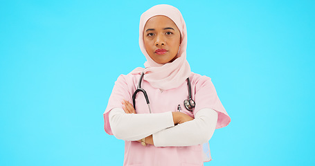 Image showing Face, nurse and Muslim woman shaking head in studio isolated on blue background mockup. Portrait, arms crossed and serious healthcare professional or Islamic person with disagreement, no or rejection