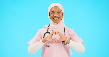 Image showing Face, nurse and Muslim woman with heart hands in studio isolated on a blue background mockup. Smile, portrait and happy medical professional or Islamic person with emoji or symbol for love and care.