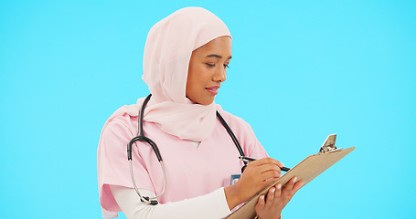 Image showing Woman, doctor and writing on clipboard in studio for information or medical record. Islamic or muslim female and professional nurse in hijab with list for healthcare insurance on blue background