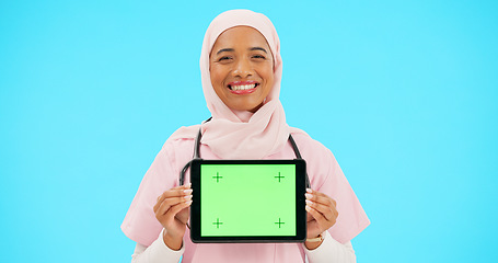 Image showing Woman, doctor and tablet green screen in studio for website information or medical record app. Muslim female or professional nurse in hijab and mobile device for online healthcare on blue background