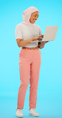 Image showing Happy, email and a Muslim woman with a laptop for work isolated on a blue background in a studio. Smile, online and an Islamic employee typing on a computer, sending response and reading on the web