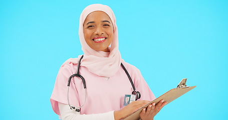 Image showing Woman, doctor and clipboard portrait in studio for information or medical records. Islamic or muslim female and professional nurse in hijab with smile and document for healthcare on blue background