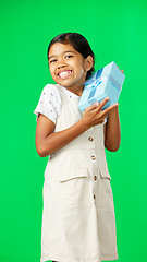 Image showing Excited, gift and face of a girl on a green screen isolated on a studio background. Shaking, happy and portrait of a girl with excitement about a birthday, Christmas or holiday present on a backdrop