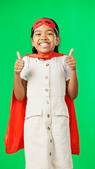 Image showing Little girl, superhero and thumbs up on green screen for success against a studio background. Portrait of happy adorable child or kid in hero cosplay showing thumb emoji, yes sign or like on mockup