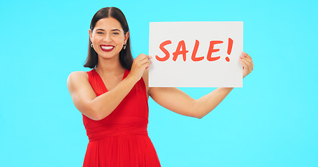 Image showing Woman holding sale poster isolated on blue background for retail, shopping or customer discount announcement. Happy face of person with fashion promotion, deal or cardboard sign in studio advertising