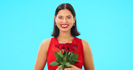 Image showing Rose flowers, face and happy woman in studio, blue background and color backdrop. Portrait of female model, plant bouquet and floral gift for celebration of love, romantic present and valentines day