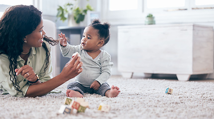 Image showing Black baby, mother and toy letter blocks for language development on living room floor. Family home, teaching and mom with girl toddler learning with happiness and a smile with love and mockup