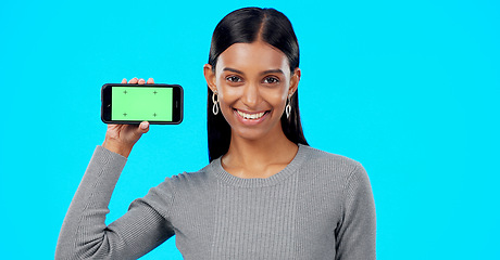 Image showing Woman, happy and phone green screen mockup with a smile for advertising website space. Face portrait of indian female model show smartphone for branding app, logo promotion or ux while excited