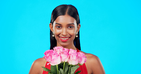 Image showing Face, flower bouquet and happy beauty woman with nature gift, sustainable agriculture portrait or natural present. Eco friendly product, floral studio roses and female person smile on blue background