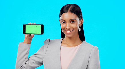 Image showing Chroma key, green screen and businesswoman holding phone for product place, branding and mobile app advertising. Smile, happy and portrait of professional female isolated in a studio blue background