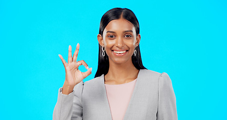 Image showing Perfect, satisfied and businesswoman with ok hand gesture, sign or symbol feeling happy isolated in studio blue background. Smile, excited and portrait of satisfied female showing yes and approval