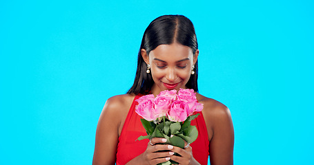 Image showing Face, flower bouquet and happy beauty woman with nature gift, sustainable agriculture portrait or natural present. Eco friendly product, floral studio roses and female person smile on blue background