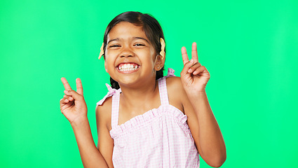 Image showing Children, peace and the portrait of a girl on a green screen background in studio with a hand gesture. Kids, happy or emoji with an adorable and playful little female child on chromakey mockup