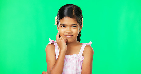 Image showing Thinking, green screen and idea by child with a question feeling excited, thoughtful and isolated in studio background. Planning, girl and joyful kid is happy, curious and planning expression