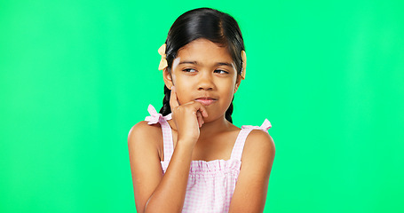 Image showing Thinking, green screen and idea by child with a question feeling excited, thoughtful and isolated in studio background. Planning, girl and joyful kid is happy, curious and planning expression