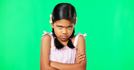 Image showing Angry, crossed arms and face of child on green screen with upset, disappointed and anger expression. Emoji, mockup studio and portrait of isolated young girl mad, unhappy and shake head for problem