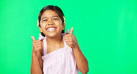 Image showing Happy, excited and face of a child with thumbs up on a green screen isolated on a studio background. Success, review and portrait of a girl showing an emoji hand icon for satisfaction and like