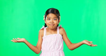 Image showing Portrait, happy and a girl shrugging on a green screen background in studio to gesture doubt or whatever. Smile, question and confused with an adorable little female child on chromakey mockup