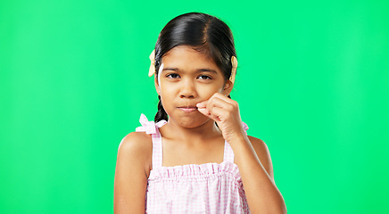 Image showing Children, secret and trust with a girl on a green screen background in studio zipping her lips. Portrait, kids and silent with an adorable little female child making a promise to keep quiet