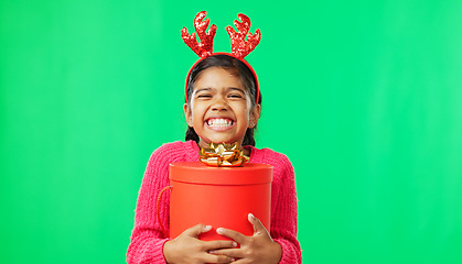 Image showing Christmas, gift box and happy with girl in green screen studio for youth, celebration and festive. Present, cheerful and vacation with portrait of child on background for season, holiday or happiness